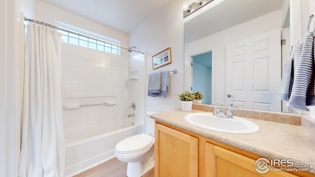 full bathroom featuring vanity, shower / bath combo with shower curtain, and toilet