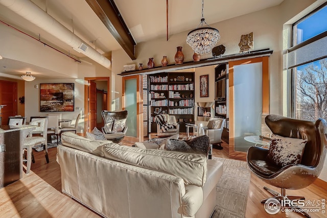 210 W Magnolia St Unit 320, Fort Collins, CO 80521 - interior space featuring wood finished floors and a notable chandelier