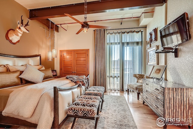 210 W Magnolia St Unit 320, Fort Collins, CO 80521 - bedroom with wood finished floors and beam ceiling
