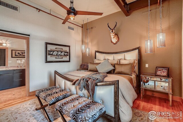 210 W Magnolia St Unit 320, Fort Collins, CO 80521 - bedroom featuring light wood finished floors, connected bathroom, visible vents, and baseboards
