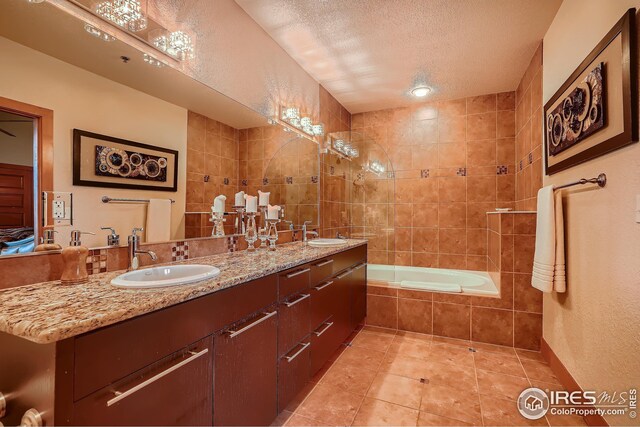 210 W Magnolia St Unit 320, Fort Collins, CO 80521 - bathroom featuring double vanity, a textured ceiling, tile patterned flooring, and a sink