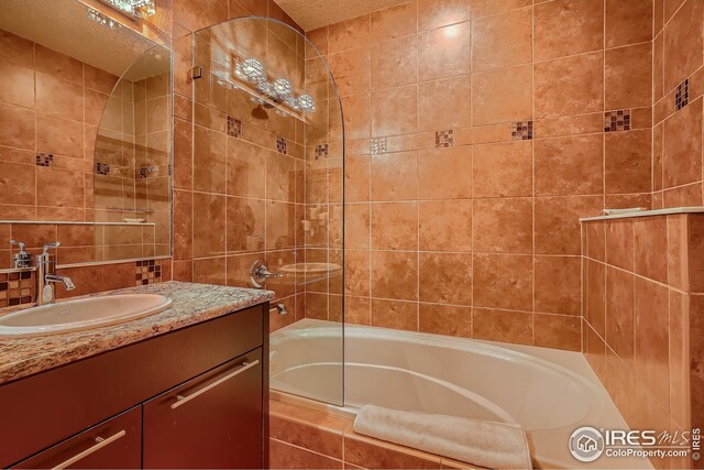 210 W Magnolia St Unit 320, Fort Collins, CO 80521 - bathroom with tile walls, vanity, and  shower combination