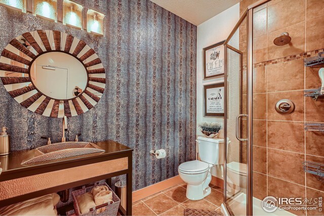210 W Magnolia St Unit 320, Fort Collins, CO 80521 - bathroom featuring toilet, tile patterned flooring, and a shower stall