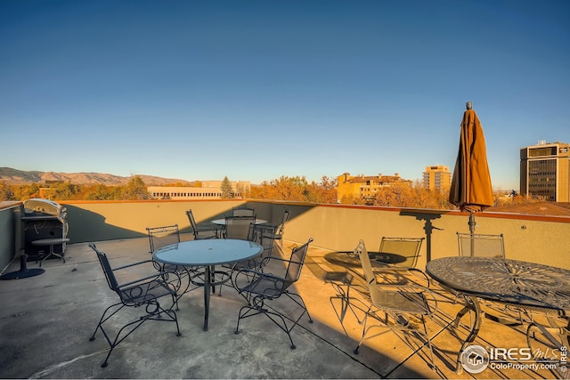 210 W Magnolia St Unit 320, Fort Collins, CO 80521 - view of patio / terrace with area for grilling, outdoor dining area, and a mountain view