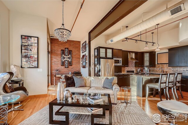 210 W Magnolia St Unit 320, Fort Collins, CO 80521 - living room featuring track lighting, an inviting chandelier, light wood-style floors, and visible vents