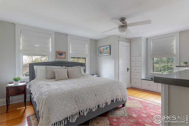 bedroom with ceiling fan and light wood-type flooring