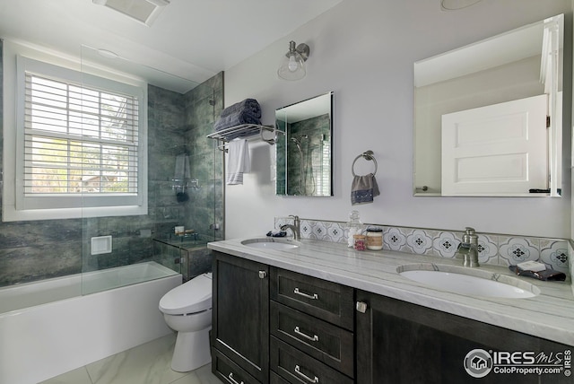 bathroom with toilet, shower / bath combination, visible vents, and a sink