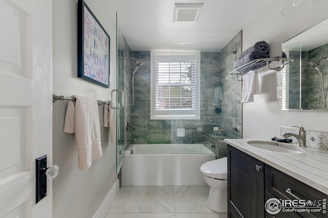 bathroom with visible vents, vanity, toilet, baseboards, and shower / tub combination