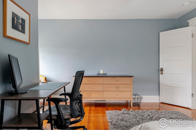 office area featuring baseboards and wood finished floors