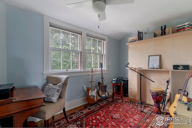 office area with baseboards, ceiling fan, and wood finished floors
