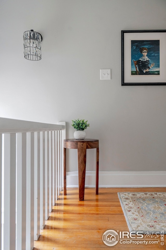 stairs with baseboards and wood finished floors