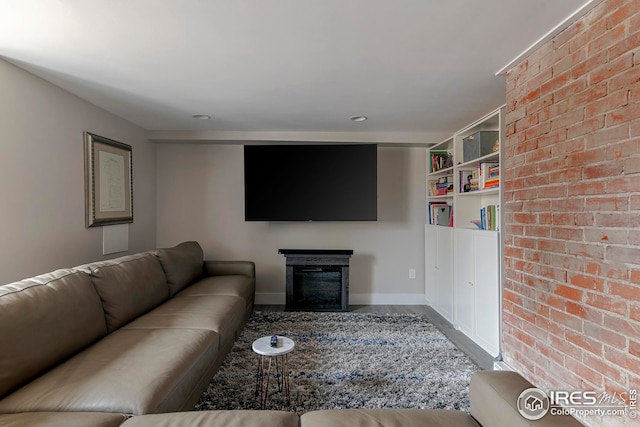living room featuring baseboards, a fireplace, and wood finished floors