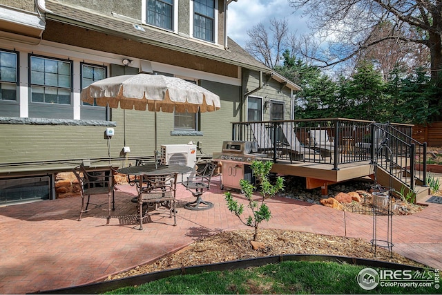 view of patio with stairway, grilling area, and a wooden deck