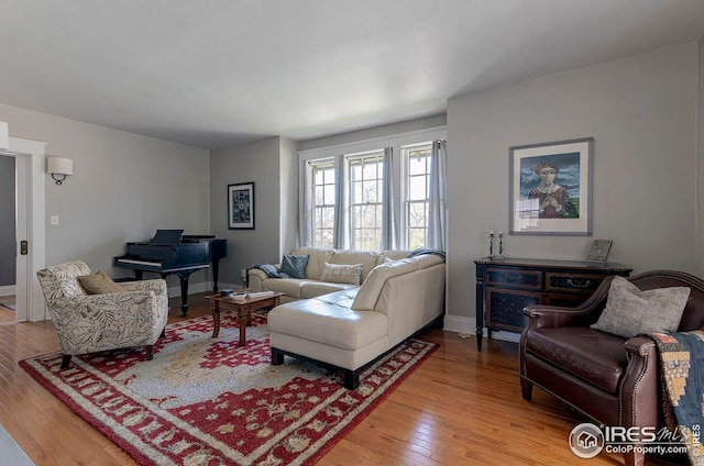 living area with light wood-style floors and baseboards