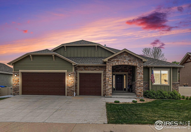 craftsman-style house featuring concrete driveway, an attached garage, board and batten siding, and stone siding