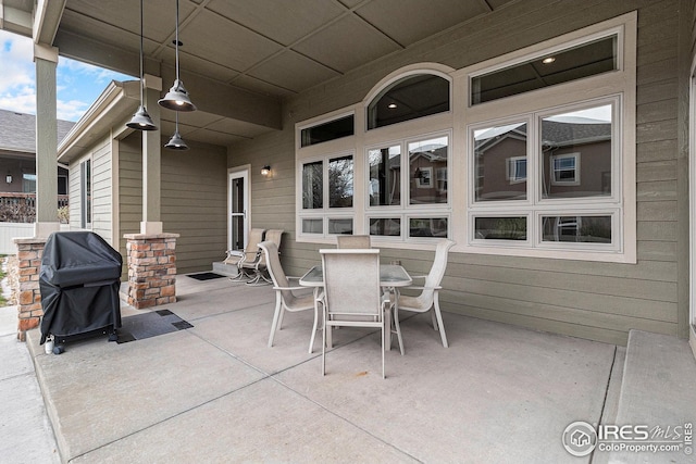 view of patio with outdoor dining space and a grill