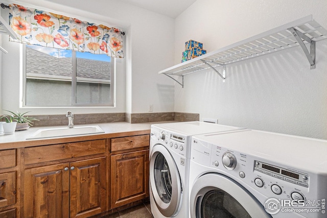 laundry area featuring a sink, cabinet space, and independent washer and dryer