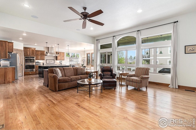 living room with visible vents, recessed lighting, light wood finished floors, and ceiling fan