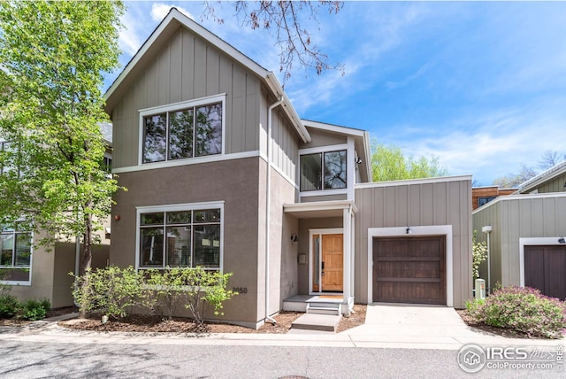 contemporary house with concrete driveway, board and batten siding, and a garage