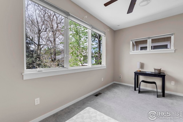 interior space with visible vents, baseboards, ceiling fan, and carpet floors