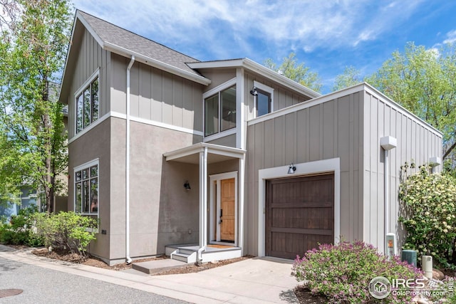 modern home featuring a garage, board and batten siding, and concrete driveway