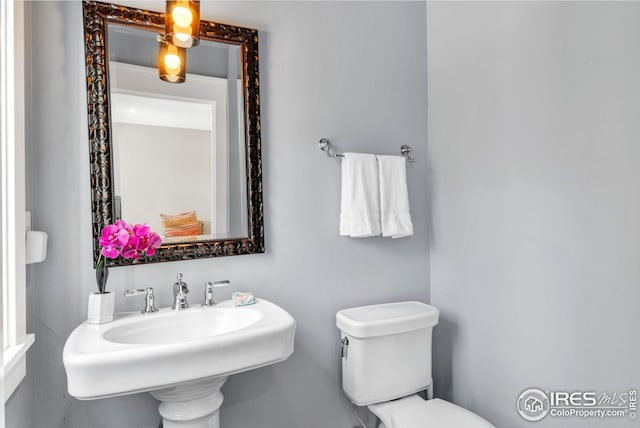 bathroom with toilet and a sink