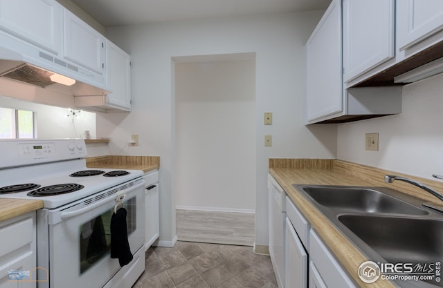 kitchen featuring a sink, baseboards, custom exhaust hood, white appliances, and white cabinetry