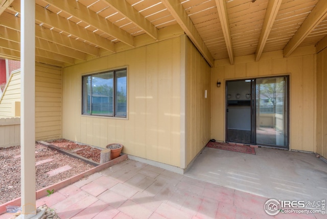 view of exterior entry featuring a patio area