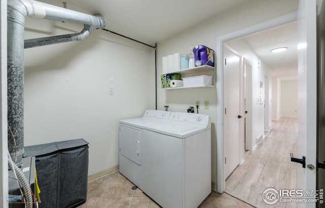 clothes washing area featuring separate washer and dryer and laundry area