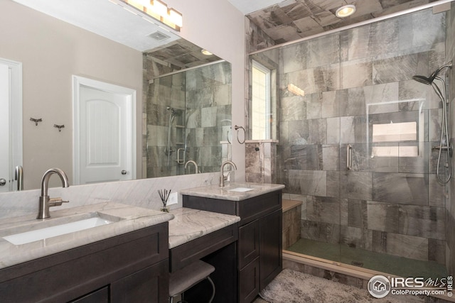 bathroom featuring visible vents, a shower stall, and vanity