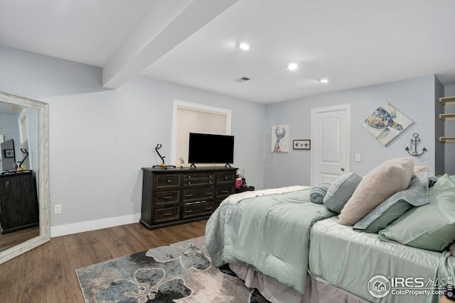 bedroom with visible vents, wood finished floors, beamed ceiling, baseboards, and recessed lighting