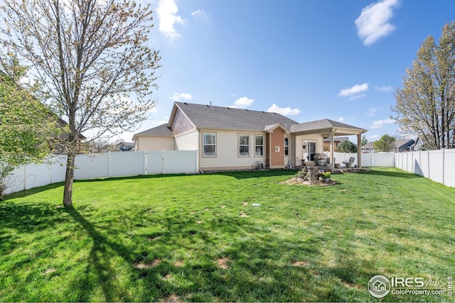 back of property featuring a fenced backyard and a yard