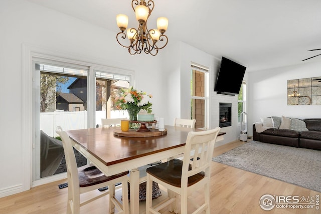 dining area featuring an inviting chandelier, light wood finished floors, and a wealth of natural light