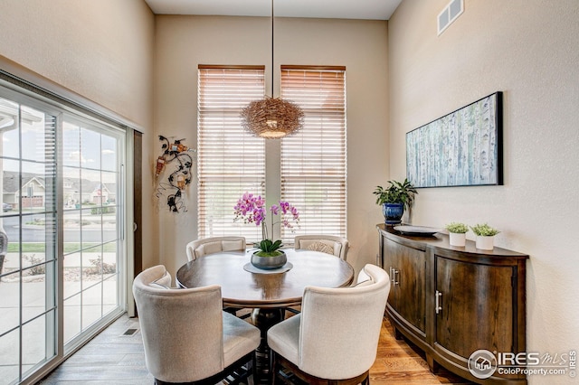 dining area featuring visible vents and light wood-style flooring