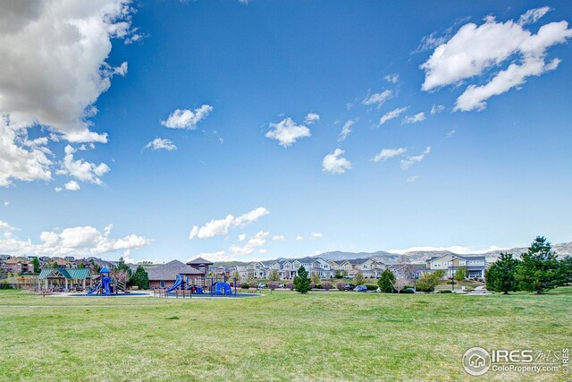 view of yard featuring a residential view and playground community