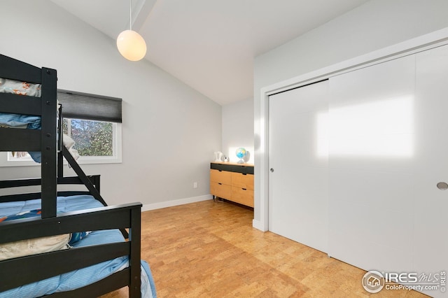 bedroom featuring baseboards and vaulted ceiling