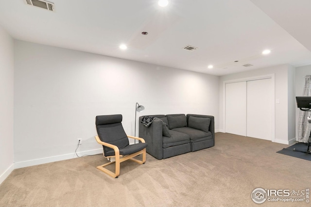 living area featuring visible vents, recessed lighting, and carpet