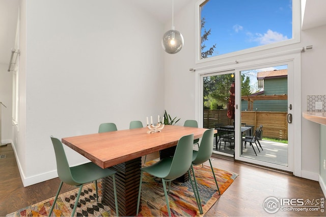 dining area featuring baseboards and wood finished floors