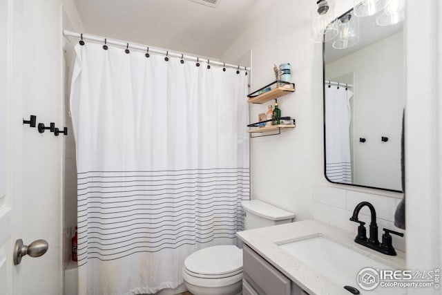 8596 Seattle Slew Ln, Wellington, CO 80549 - full bathroom featuring vanity, shower / tub combo, backsplash, and toilet