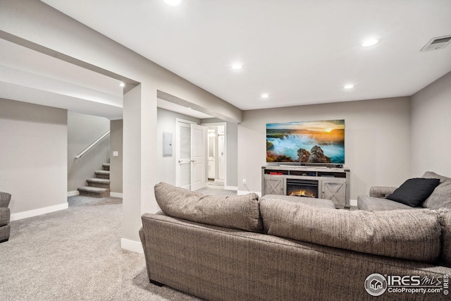 8596 Seattle Slew Ln, Wellington, CO 80549 - carpeted living room featuring a lit fireplace, visible vents, stairs, baseboards, and recessed lighting