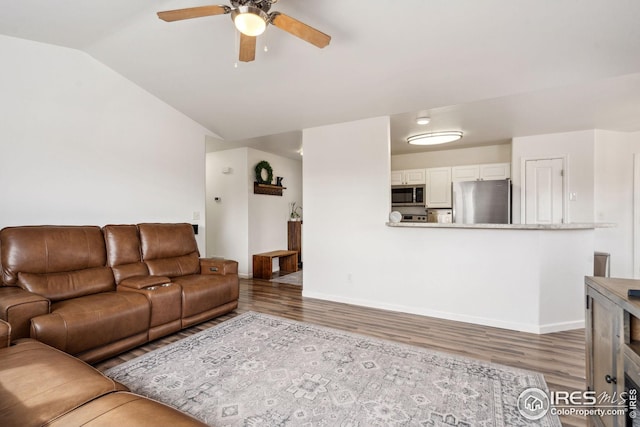 8596 Seattle Slew Ln, Wellington, CO 80549 - living room featuring a ceiling fan, baseboards, vaulted ceiling, and wood finished floors