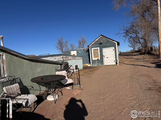 view of patio / terrace with a storage unit and an outbuilding