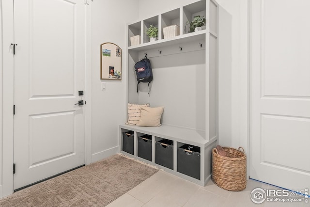 mudroom featuring baseboards and tile patterned flooring