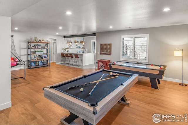 game room featuring baseboards, pool table, a bar, and wood finished floors