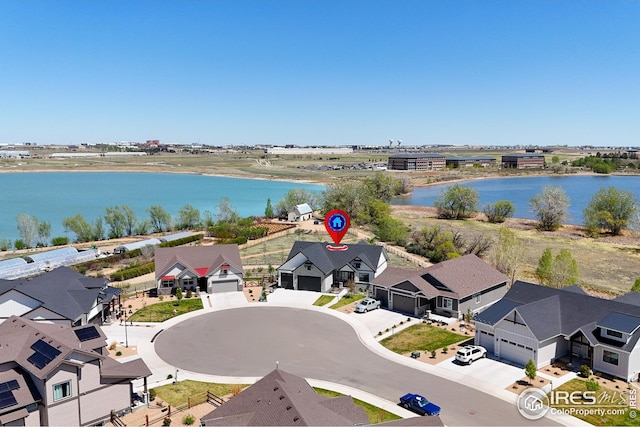 bird's eye view with a residential view and a water view