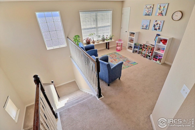 carpeted living room with baseboards