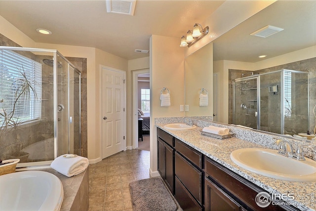 ensuite bathroom with ensuite bathroom, a sink, visible vents, and a shower stall