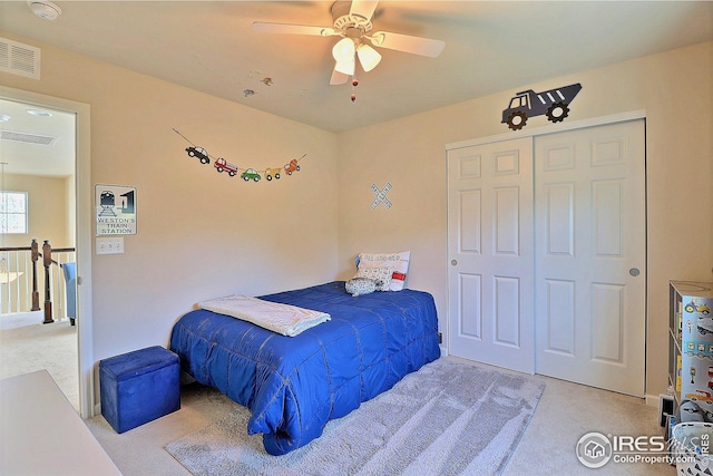bedroom featuring visible vents, carpet, and a closet