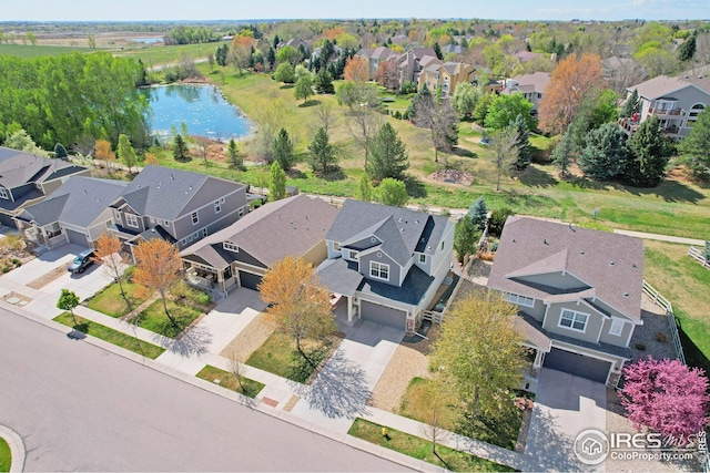 bird's eye view with a residential view and a water view