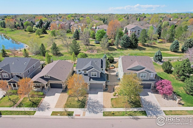 birds eye view of property featuring a water view and a residential view
